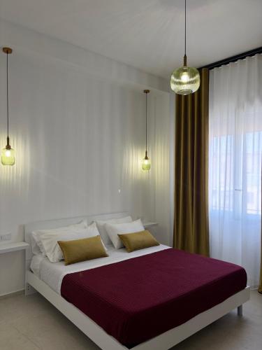 a bedroom with a large bed with two pillows at Trapani Urban Nest in Trapani