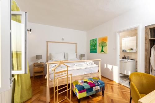 a bedroom with a bed and a chair in it at House Erin Tara Sigrid, Hvar in Hvar
