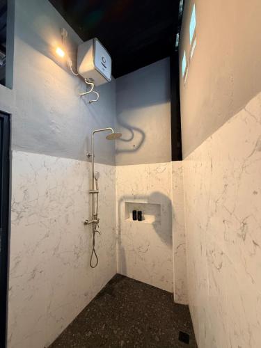 a bathroom with a shower with a shower head at Uma Pirates Lombok in Mataram