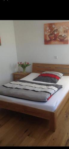 a large bed in a room with a wooden frame at Top Ferienwohnung Herborn in Herborn
