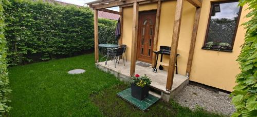 a house with a porch with a table and a desk at Apartmán v Královském Údolí s předzahrádkou in Králŭv Dvŭr