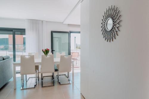 a dining room with a table and white chairs at Apartment - Casa Andres in Salir de Porto
