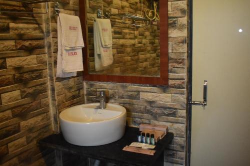 a bathroom with a sink and a mirror at Hotel Ridley International in Digha