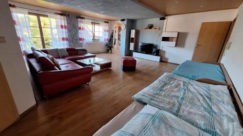 a living room with a bed and a couch at Ferienwohnung Kohler - Königsfeld in Königsfeld