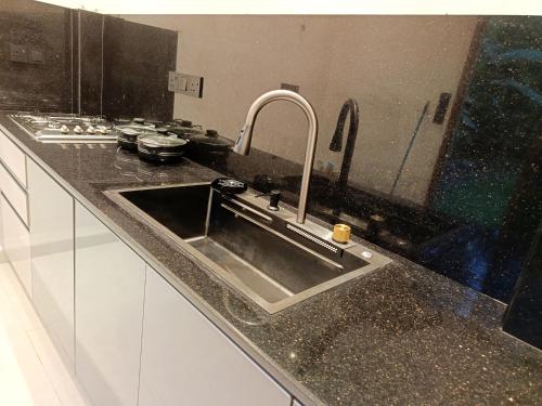 a kitchen sink with a faucet in a kitchen at Isle Weligama in Weligama