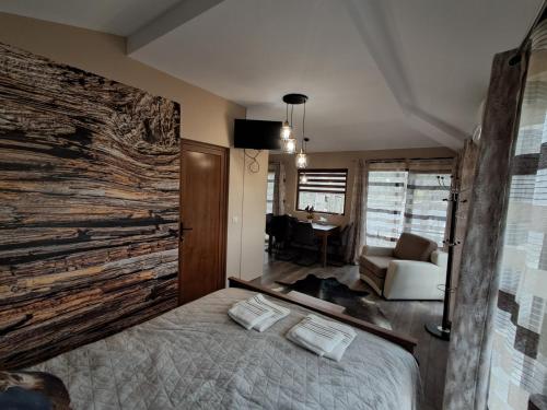 a bedroom with a large wooden wall with a bed at Къща Шепотът на бора in Varna City