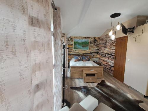 a bathroom with a sink and a stone wall at Къща Шепотът на бора in Varna City