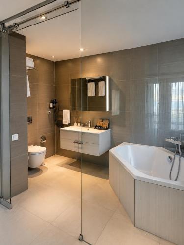 a bathroom with a tub and a sink and a toilet at The Sign Highlight Hotel in Bodrum City