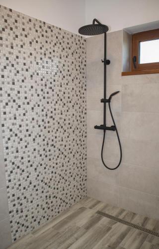a bathroom with a shower with a shower head at 4 Fa Apartmanok in Miercurea-Ciuc