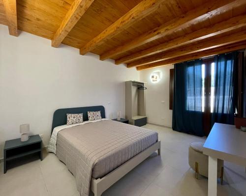 a bedroom with a bed and a wooden ceiling at Asmara 10 in Trapani