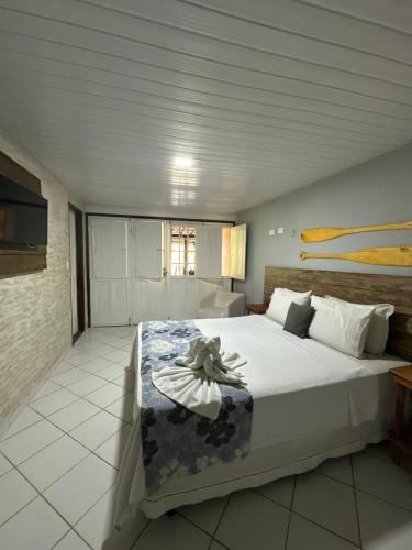 a bedroom with a large bed in a room at Pousada Maraoka in Porto De Galinhas