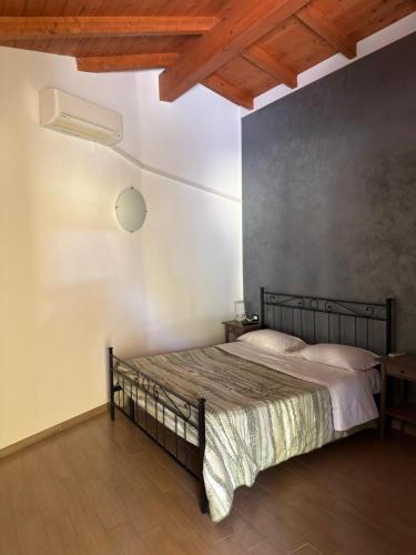 ein Schlafzimmer mit einem schwarzen Bett in einem Zimmer in der Unterkunft Samarcanda Hotel & Parking di Parmigiani Silvia in Civitavecchia