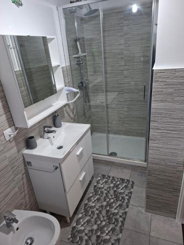 a bathroom with a toilet and a sink and a shower at Nazem Holiday in Comunanza