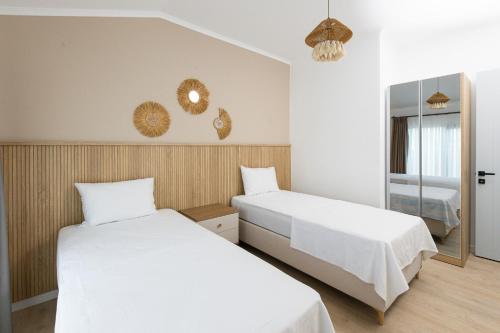 a bedroom with two beds and a mirror at Eliz Paradise By Panjur in Alanya