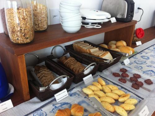 a display of different types of bread and pastries at The Hyperion Boutique Hotel in Florianópolis
