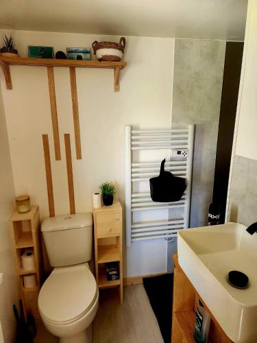 a bathroom with a toilet and a sink at Cosy camping in Crots