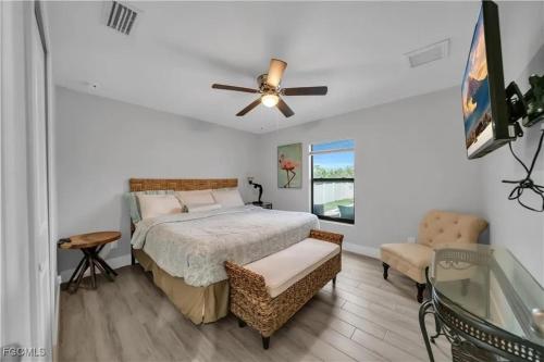 a bedroom with a bed and a ceiling fan at Southwest Florida Paradise in Cape Coral