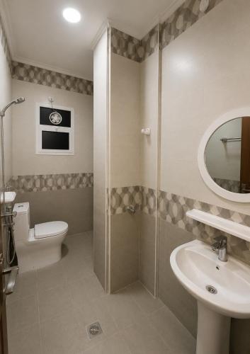 a bathroom with a shower and a toilet and a sink at RED Bn Saif in Salalah