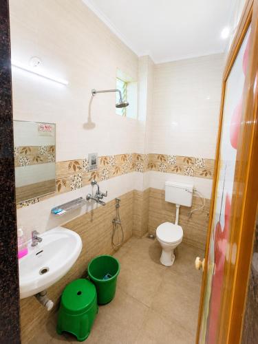 a bathroom with a sink and a toilet at Aurevia Stays - 400m from beach in Calangute