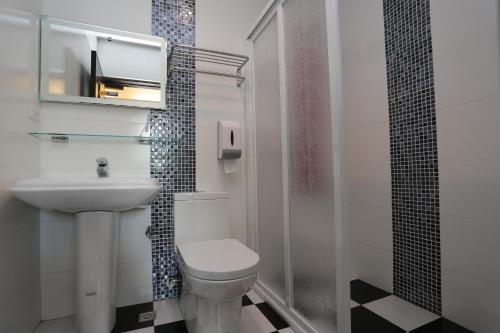 a bathroom with a toilet and a sink and a shower at Magic Homestay in Taitung City