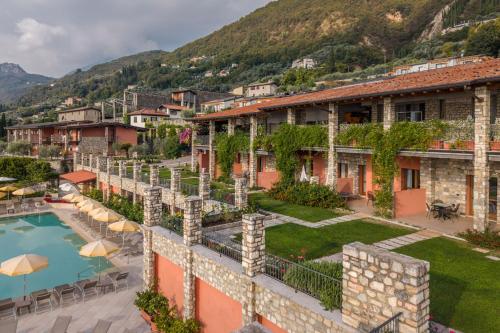 a view of a resort with a swimming pool at Residence Borgo Dei Limoni - Appartamenti con Garage in Gargnano
