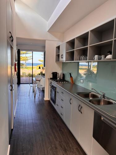 a kitchen with a sink and a counter at Esperance Waterfront Apartment in Esperance