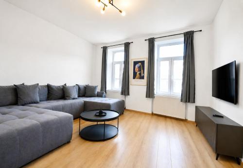 a living room with a couch and a table at Luxurious & Spacious Residence in the Heart of Brașov in Braşov