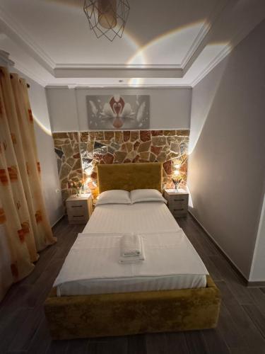 a bedroom with a large bed with lights on it at Vila Silvi Bala in Pilur