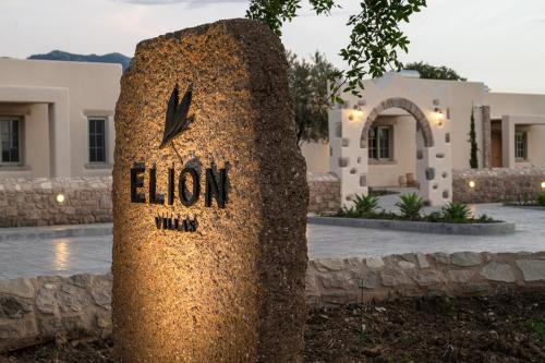 a stone clock in front of a building at Elion Private Pool Villas in Kos