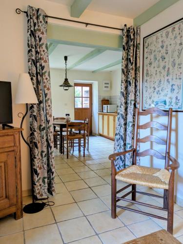 a living room with a chair and a table at Gite Les Bannes in Saint-Sauves- dʼAuvergne