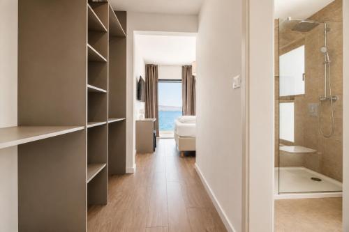 a bathroom with a walk in shower and a bedroom at Courtside Luxury Villa Dalmatia in Dobropoljana