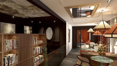 a library with a table and chairs and bookshelves at Hotel Indigo Paris - Opera by IHG in Paris