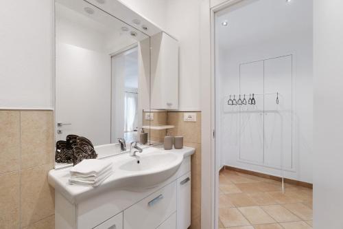 a white bathroom with a sink and a mirror at Cà da Trûcca in Varazze
