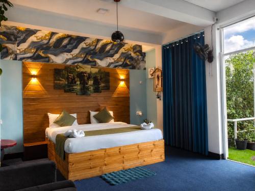 a bedroom with a bed with a wooden headboard at Off grid Ella Homestay in Ella