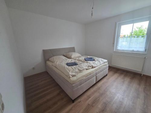 a bedroom with a bed in a room with a window at Monteuerwohnung in ruhiger Lage in Möser