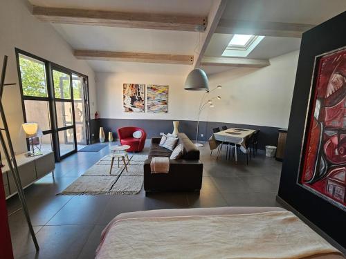 a living room with a couch and a table at Loft Casa Couderc Terrace Parking in Velaux