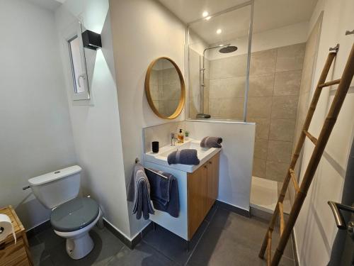 a bathroom with a sink and a toilet and a mirror at Loft Casa Couderc Terrace Parking in Velaux