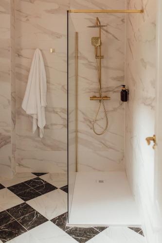 a shower with a glass door in a bathroom at Castros Homes in Santander