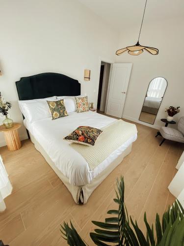 a bedroom with a large bed with white sheets at Castros Homes in Santander