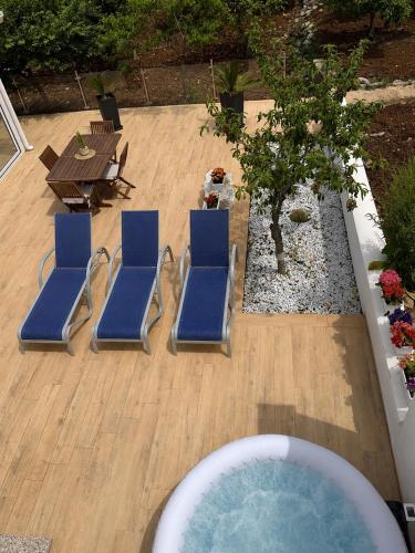 a group of blue lounge chairs and a hot tub at Villa Amelia in Capaci