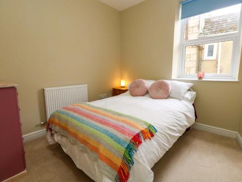 a bedroom with a bed with a rainbow blanket at Seaview Portland in Portland
