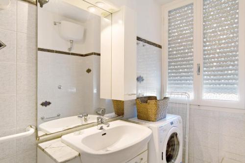 a bathroom with a sink and a washing machine at Casa La Perla in Rapallo
