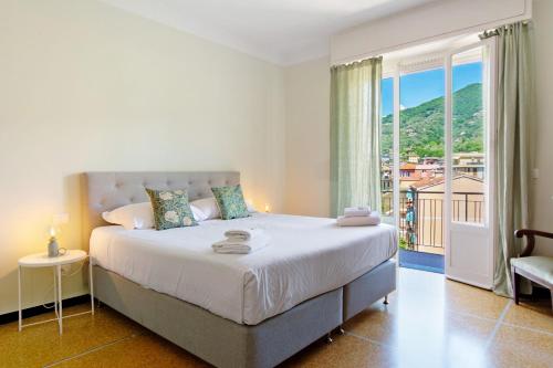 a bedroom with a large bed and a large window at Casa La Perla in Rapallo