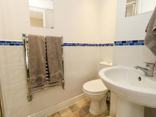 a bathroom with a white toilet and a sink at Seaview Portland in Portland