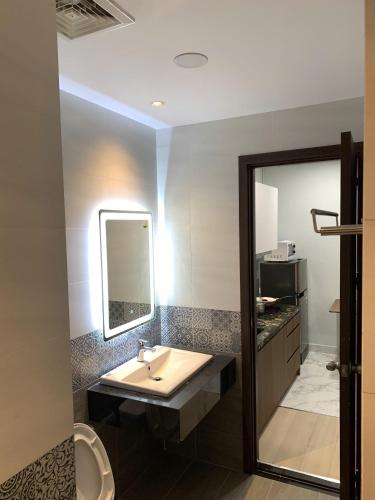 a bathroom with a sink and a mirror at Lunaria Maison - HCM Center Stay in Ho Chi Minh City