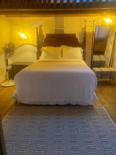 a bedroom with a large bed with a blue rug at Sigals Art B and More in Alcalá la Real