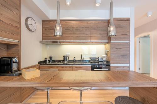 a kitchen with wooden cabinets and a large wooden table at Mierki da Marco in Mörken