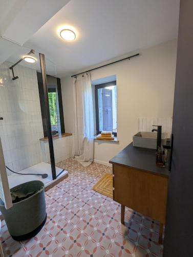 a bathroom with a shower and a sink and a tub at Les Chapeliers in Foix