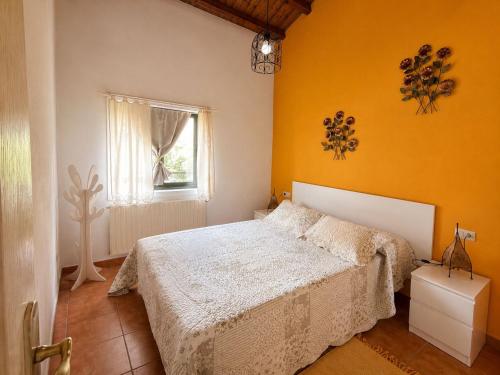 a bedroom with a white bed and a window at Los Tres Soles in Silleda