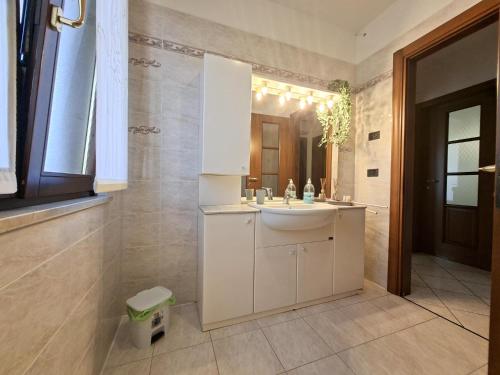 a bathroom with a white sink and a mirror at Villa Romea in Guidizzolo